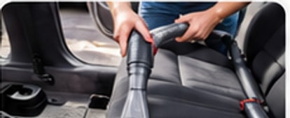 Interior vehicle seat being vacuumed